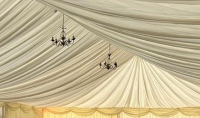 Chandeliers against a pleated ivory marquee ceiling